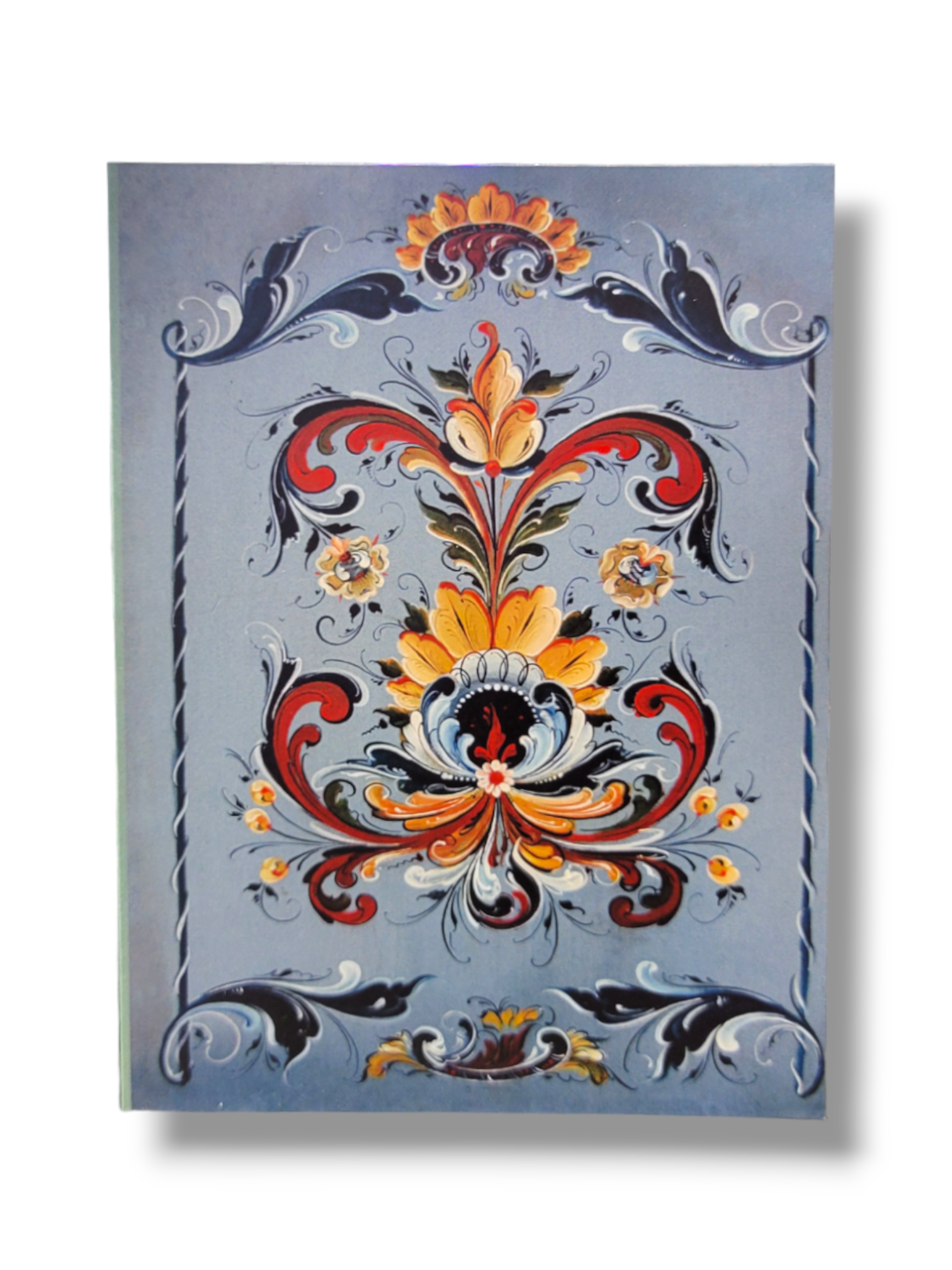 The Card Pack: Blue Rosemaling, Lise Lorentzen (12-Pack) showcases an intricate floral design with vibrant swirls and motifs set against a blue background, highlighted by red, yellow, and orange accents. These note cards come with crisp white envelopes that bring an elegant flair to your correspondence.