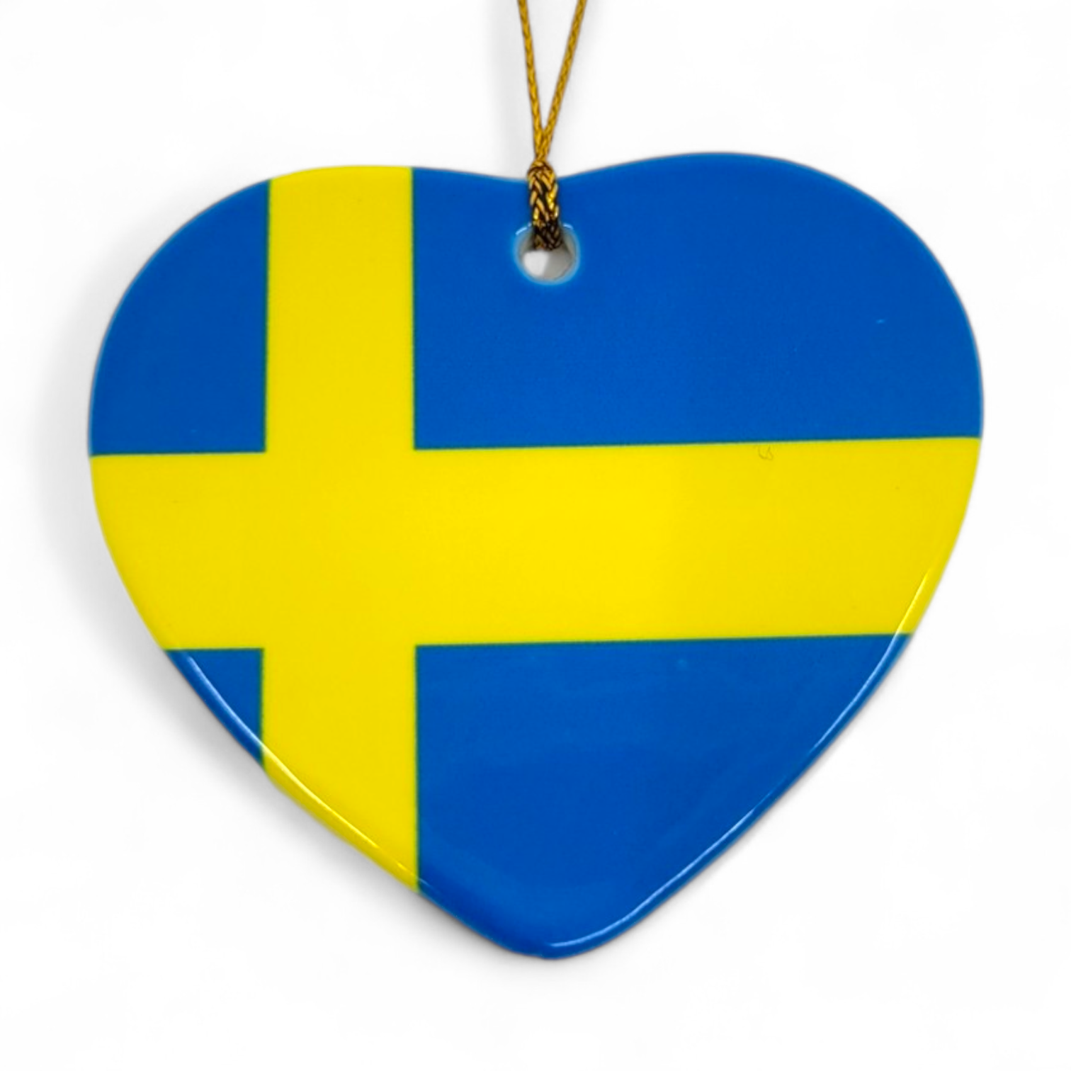 Ornament: Swedish Heart - Heart Shaped Sweden Flag Ornament 3, featuring a blue background with a yellow cross and hanging by a gold string—a charming Scandinavian keepsake for your holiday décor.