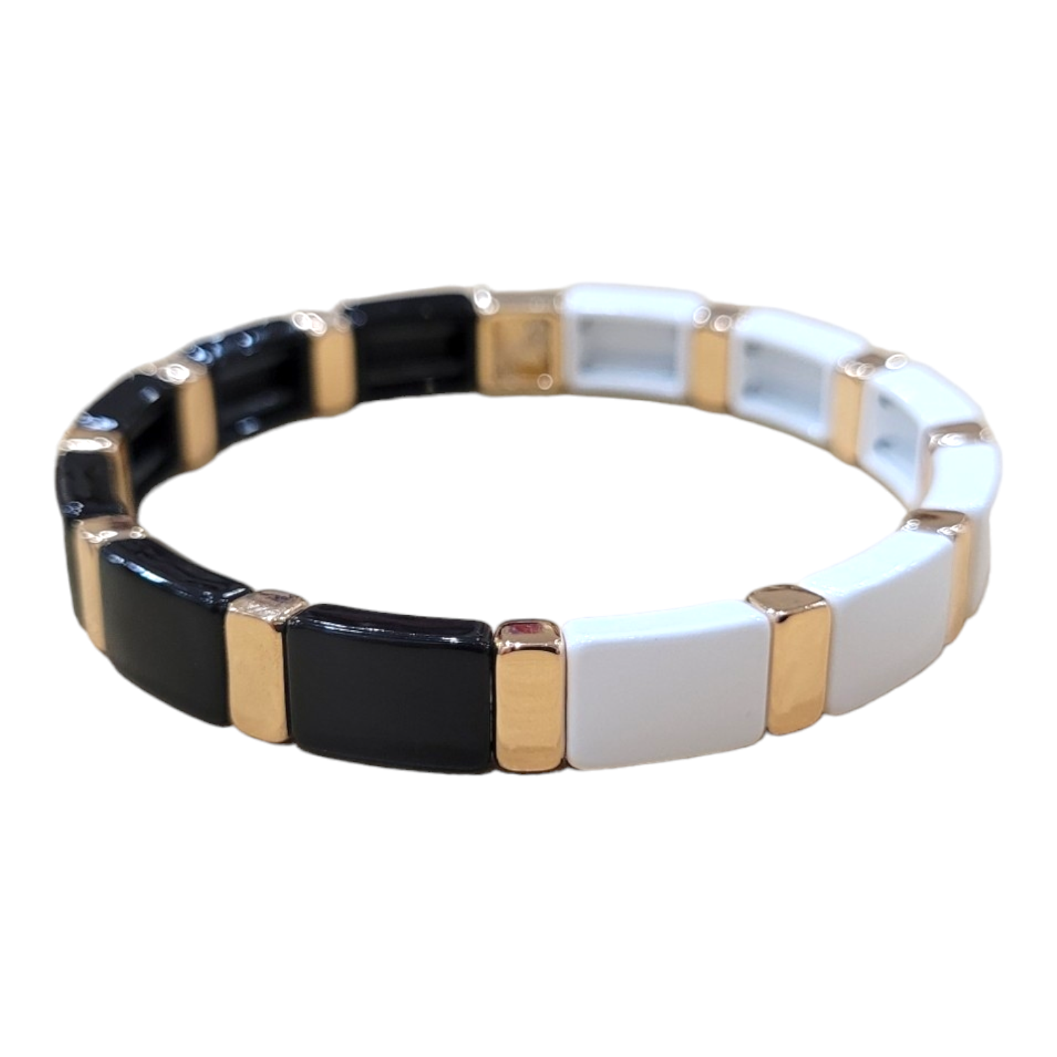 Explore the stylish Black/White Enamel Tile bracelet from A&C Oslo, featuring alternating black and white ceramic links enhanced with gold-colored accents.