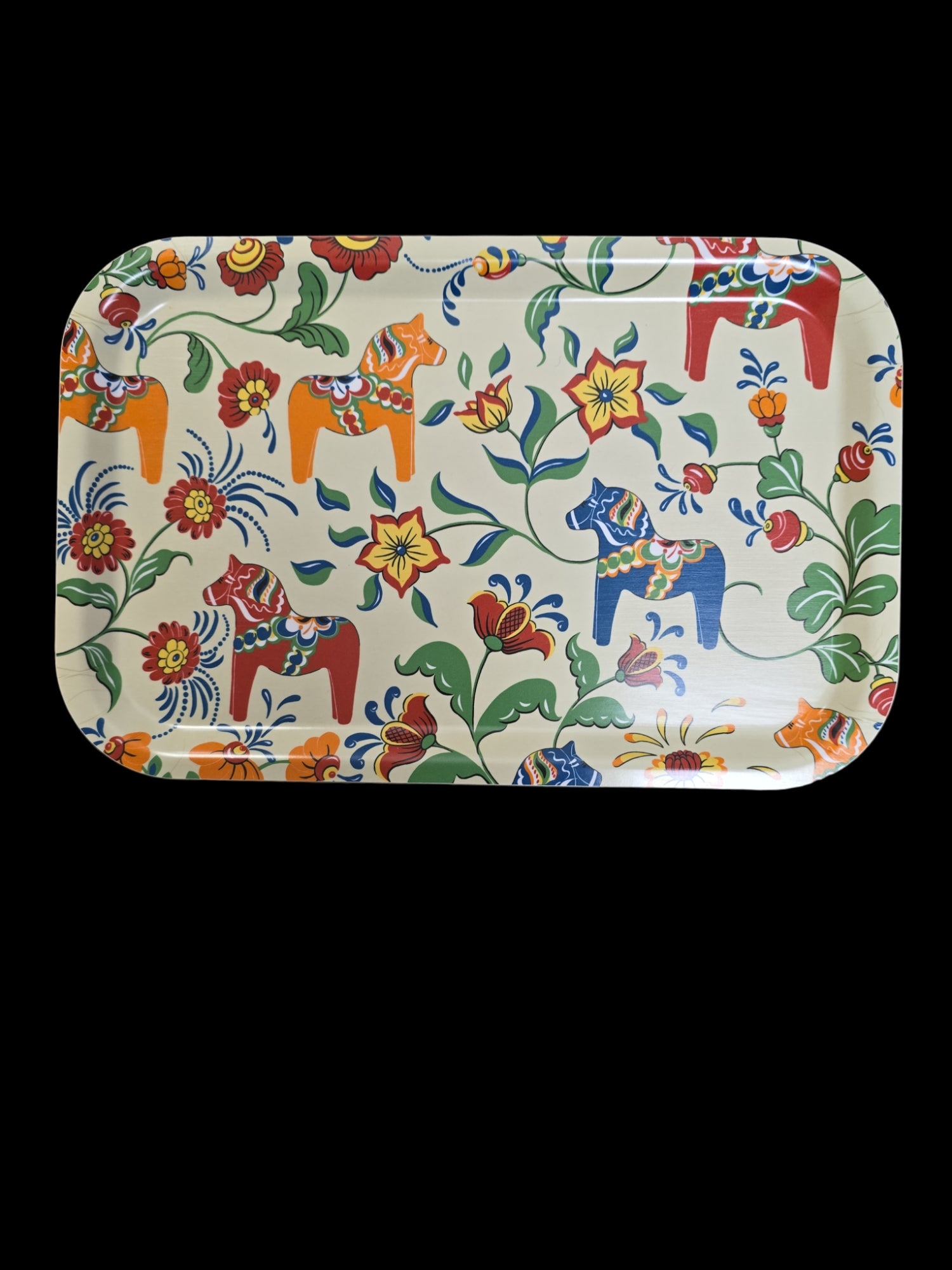 This delightful Leksand Cream Multi-Color Dala Horses tray showcases vibrant floral and Dala horse patterns set against a crisp white background, exquisitely capturing Swedish artistry.