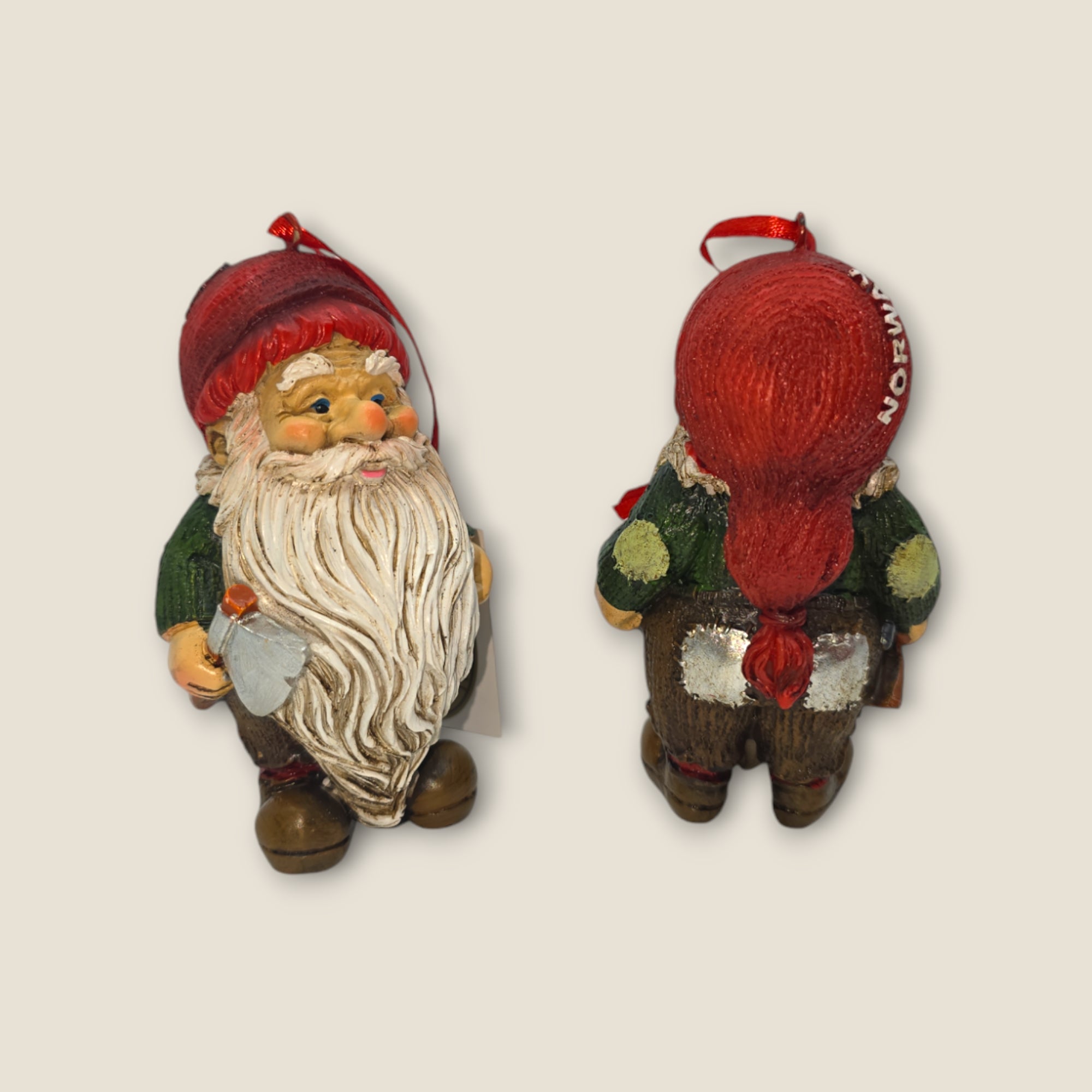 Front and back views of the 3.5 tall Norwegian Nisse Lumberjack figurine: front features a white beard, axe, red hat, and green outfit; back shows long hair with a red ribbon—ideal for collectors seeking unique Nordic gnome souvenirs.