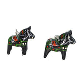 Displayed against a plain white background are the Dala Earrings Black 2cm, featuring two small, black, hand-crafted earrings shaped like Dala Horses with colorful patterns and silver hooks.