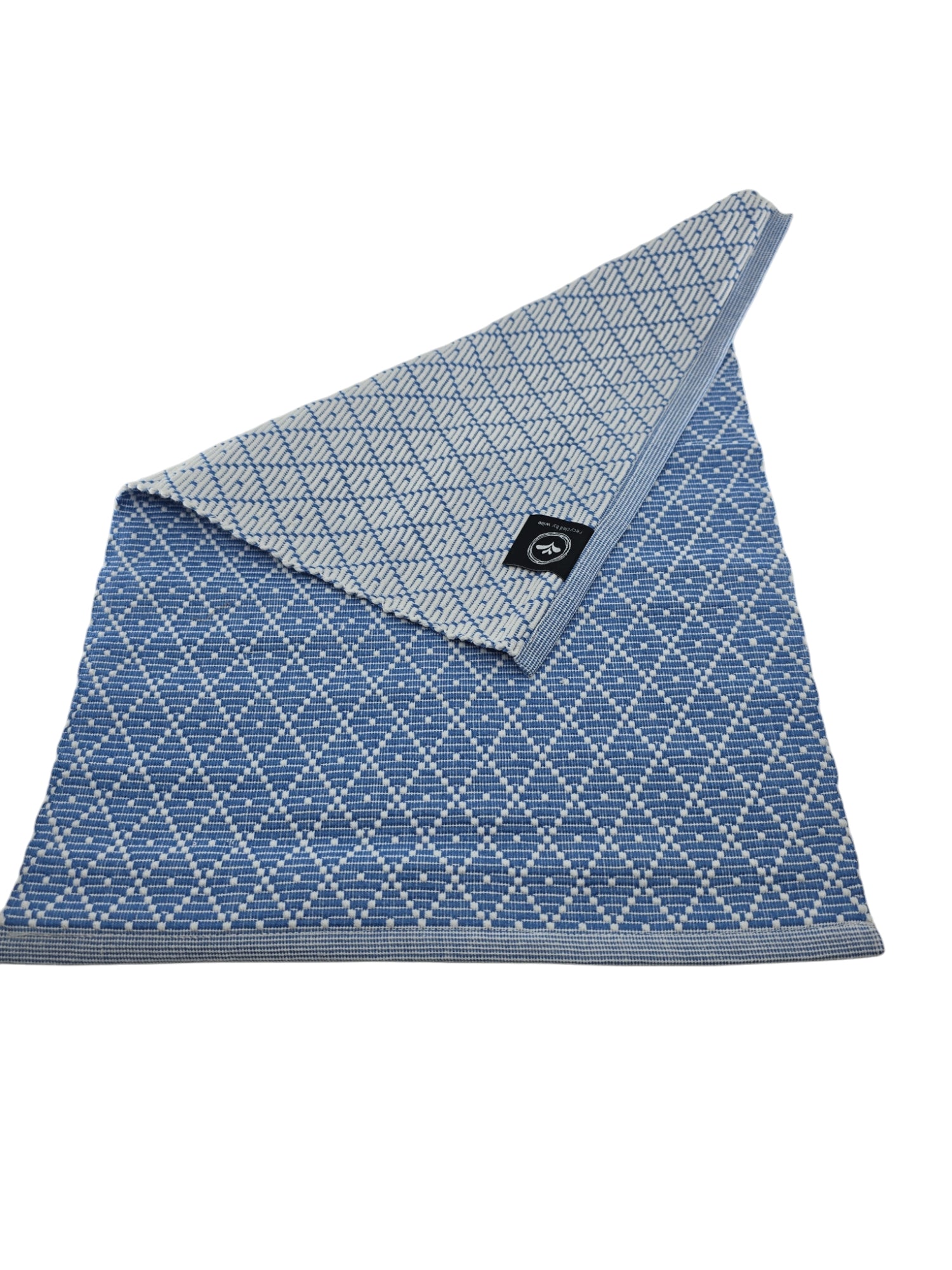 Part of the Ella Series, the Light Blue Ella Placemat by Willie features a blue and gray diamond pattern. Made from recycled textiles, it brings eco-friendly elegance to any setting with its artful design.