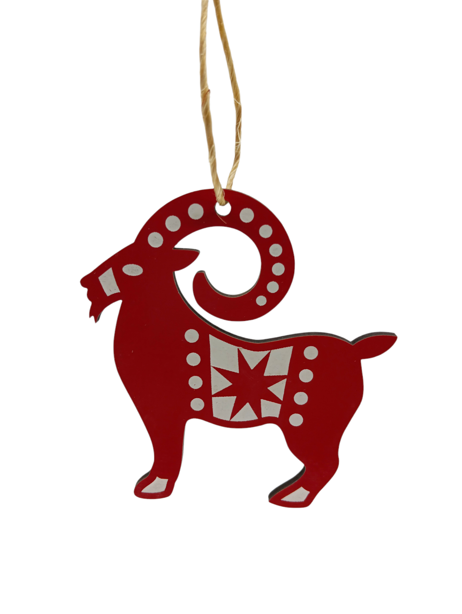 The Ornament: Straw Goat Red & White Julbok, featuring a red, goat-shaped design with curling horns and adorned with white circular accents and a star pattern, hangs gracefully by a string. This Swedish Christmas tree ornament brings charm and tradition to your holiday decor.