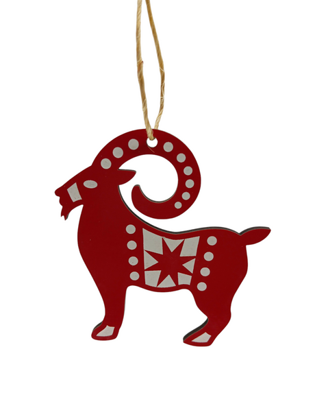 The Ornament: Jule Goat Red & White "Julbok" is a laser-cut wooden red and white goat-shaped decoration with hanging string, perfect for adding Swedish festive cheer to any space.