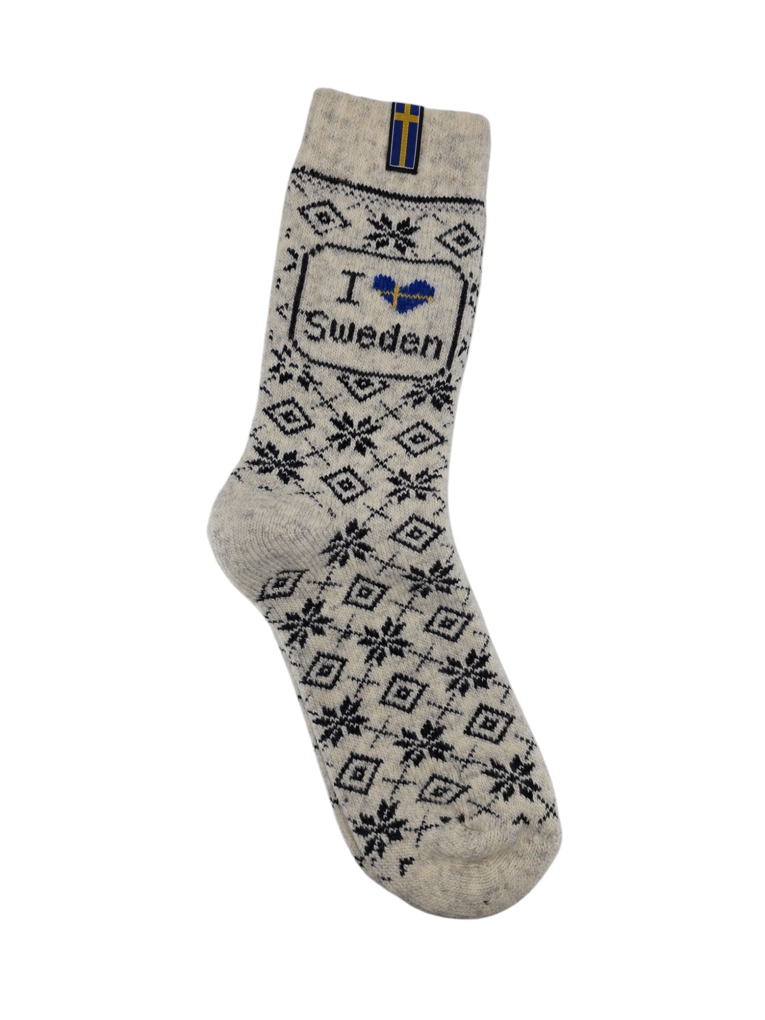 A cozy sock from Wool Wear made of an 80% wool blend, featuring black diamond and snowflake designs. It has I ♥ Sweden text and a Swedish flag label near the cuff, embracing Scandinavian charm.