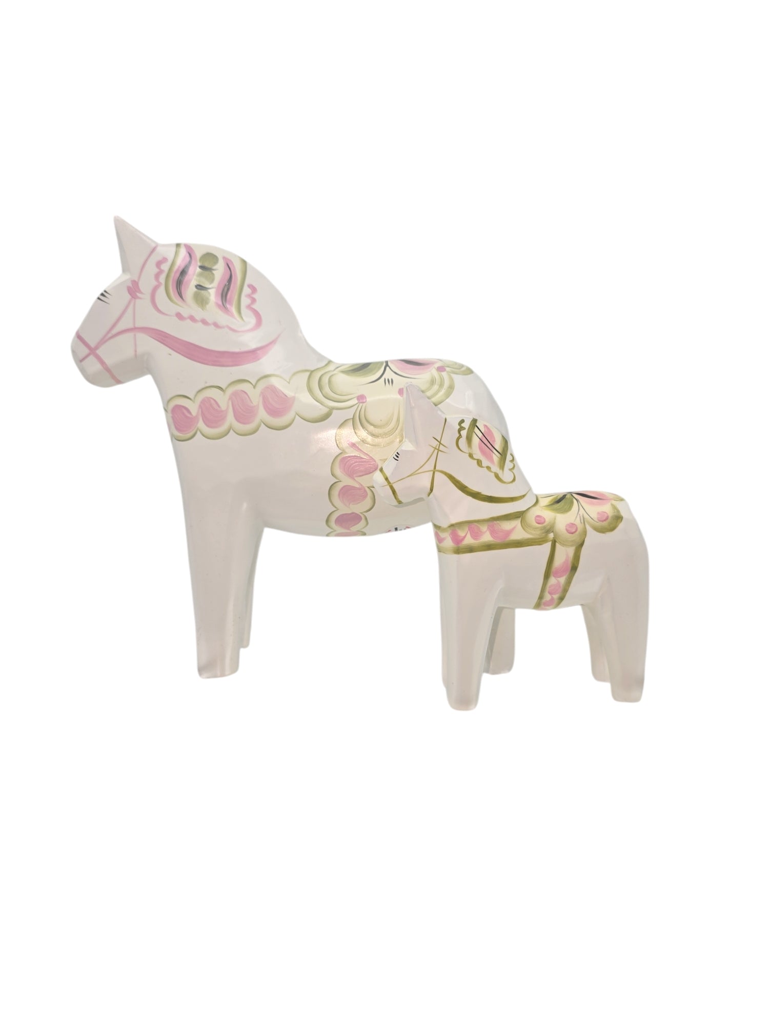 The Dala Horse: Pastel on White Swedish Dala Horse with Kurbits set includes two ceramic figures with pink and green patterns; the larger, hand-painted piece stands behind the smaller, highlighting intricate artistry reminiscent of traditional Swedish design.