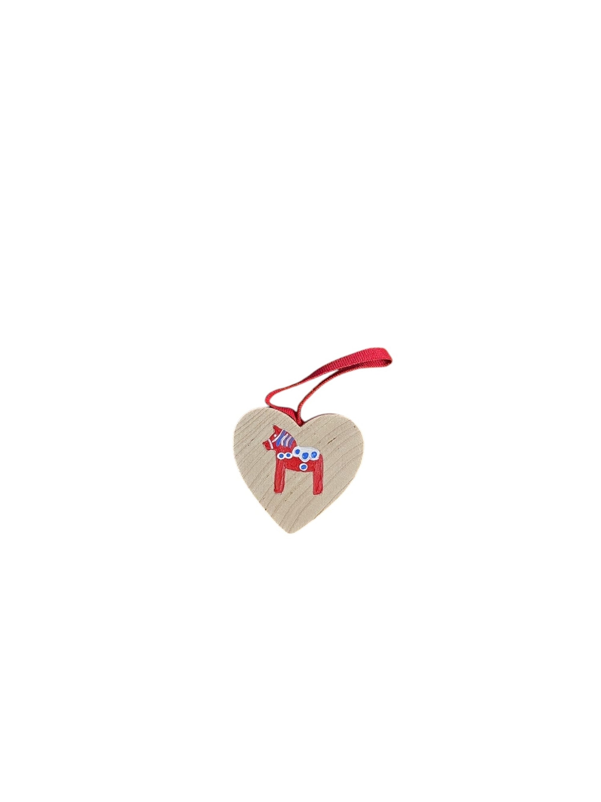 Natural heart-shaped wood ornament featuring a red Swedish Dala horse, hand-crafted in Sweden and hanging by a red ribbon.