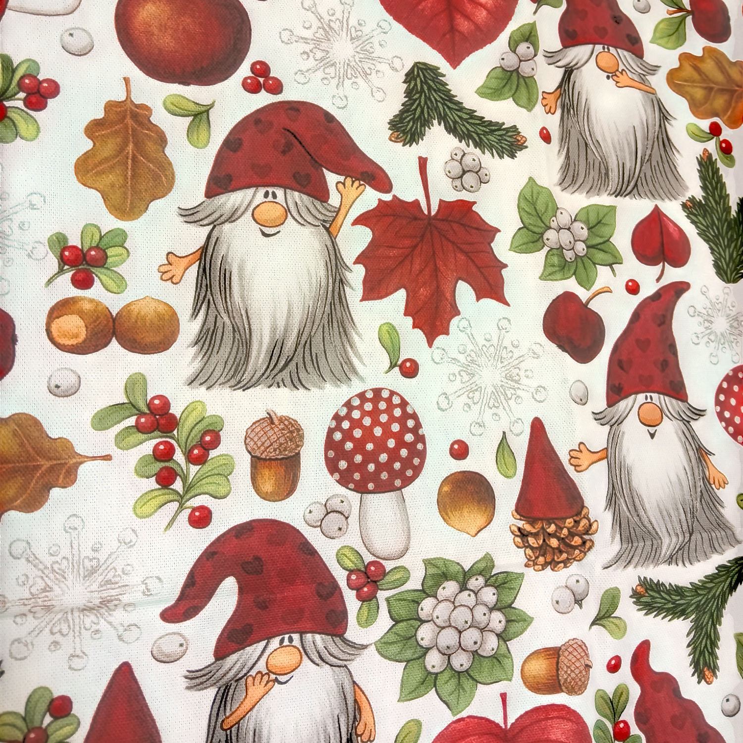 The Swedish Santas Forest Tea Towel features charming Santas in red hats, surrounded by mushrooms, acorns, autumn leaves, snowflakes, and berries on a crisp white background.