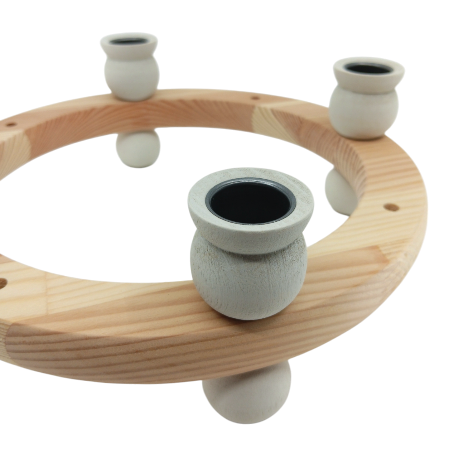 The Candle Holder: White Handcrafted Swedish Candle Ring is a wooden circular stand with four vertical light-colored pegs, ideal for customizable decorations and adding elegance to any space.