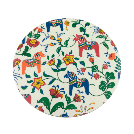 The Leksand Cream Circular Trivet, handmade in Sweden, features colorful Dala horses and floral patterns set against a white background.