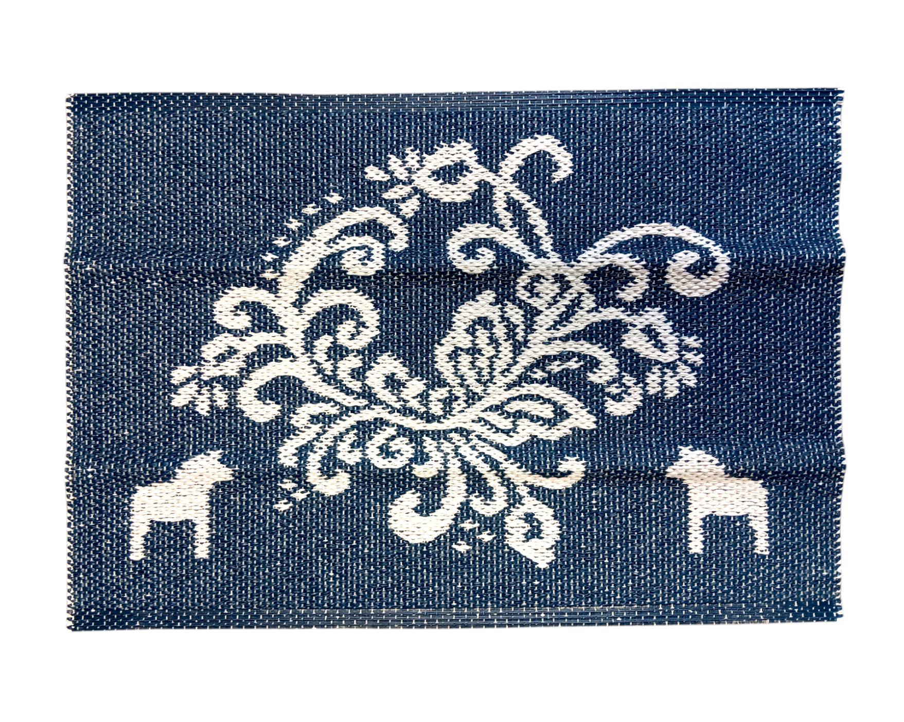 Blue woven fabric square featuring white intricate floral embroidery at the center and small Dala horse motifs on each side, echoing the Swedish Blue Kurbits Rug.