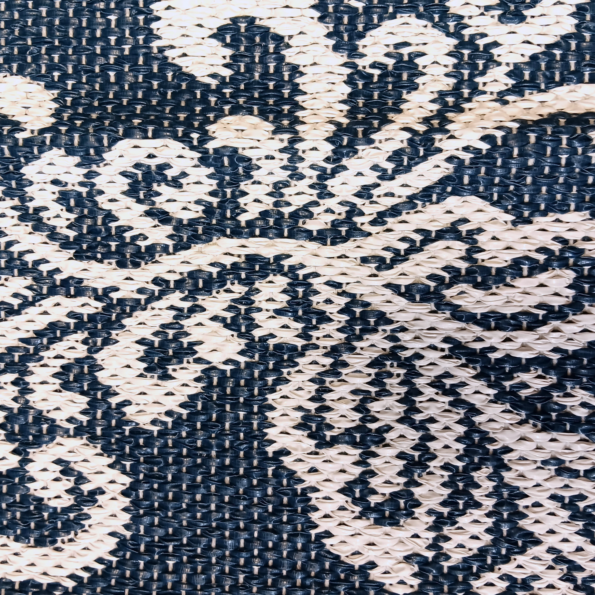 Close-up view of the Swedish Blue Kurbits Rug featuring a blue background and a detailed white floral pattern reminiscent of traditional Swedish Kurbits design.