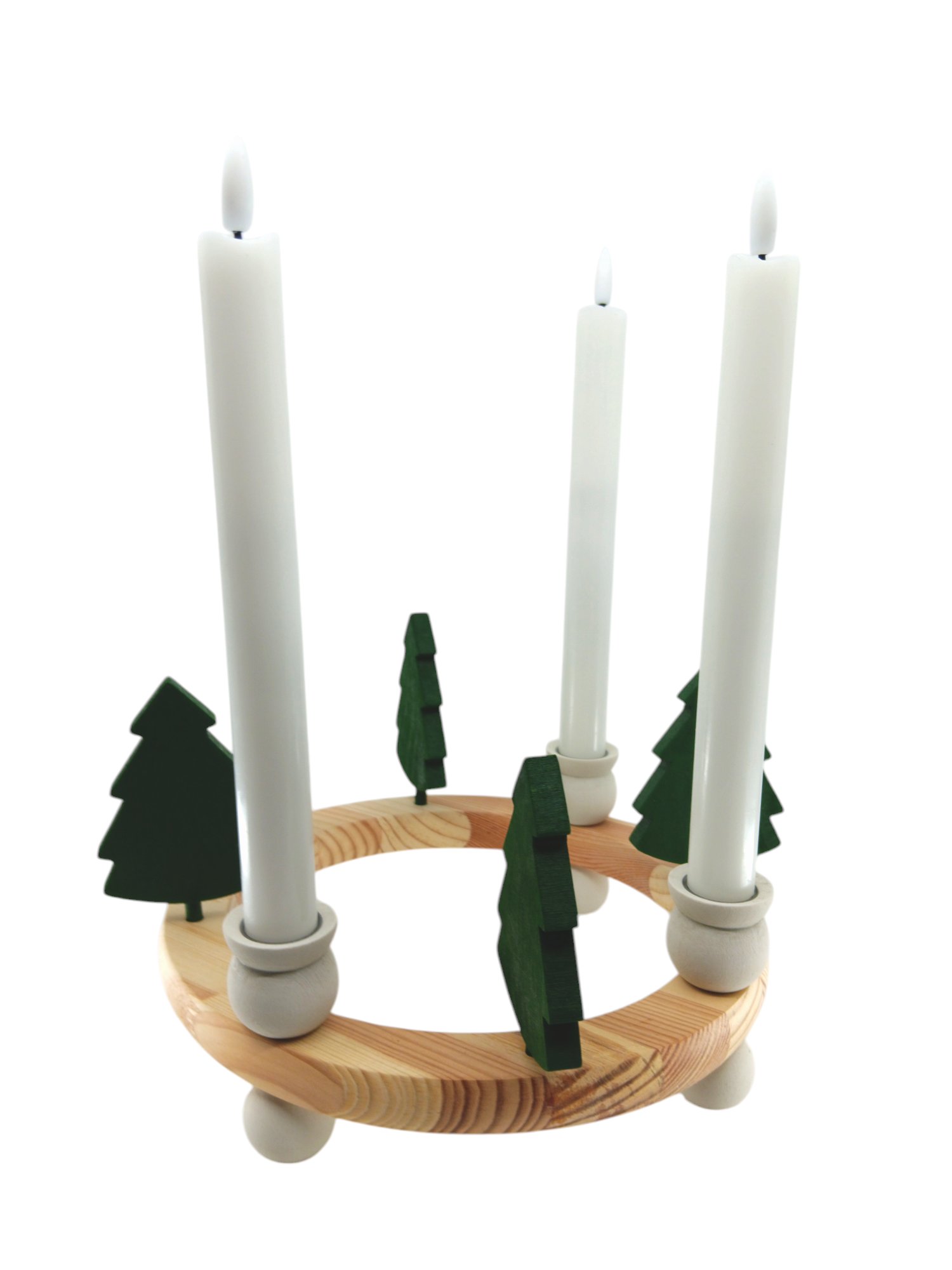 The handcrafted Swedish wood candle holder includes four lit white candles and is adorned with small green tree figurines, inspired by their Figurine: Handcrafted Swedish Wood Green Tree.