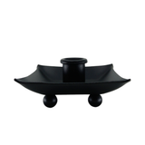 The Candle Holder: Black Iron Pillar Candle Holder 4" Square features a central cylindrical socket on a square tray with raised edges and four spherical feet. Expertly crafted in Sweden, it adds modern elegance to any setting.