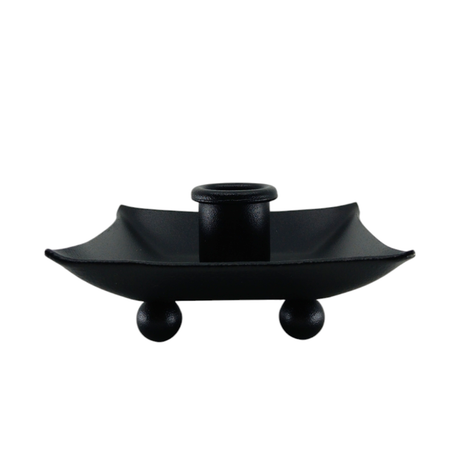 The Candle Holder: Black Iron Pillar Candle Holder 4" Square features a central cylindrical socket on a square tray with raised edges and four spherical feet. Expertly crafted in Sweden, it adds modern elegance to any setting.
