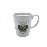 The Coffee Mug: Anna Viktoria Porcelain Mug features a light green, grey, and red kurbits folk-style pattern—bringing Scandinavian charm with heart and floral accents to your table.