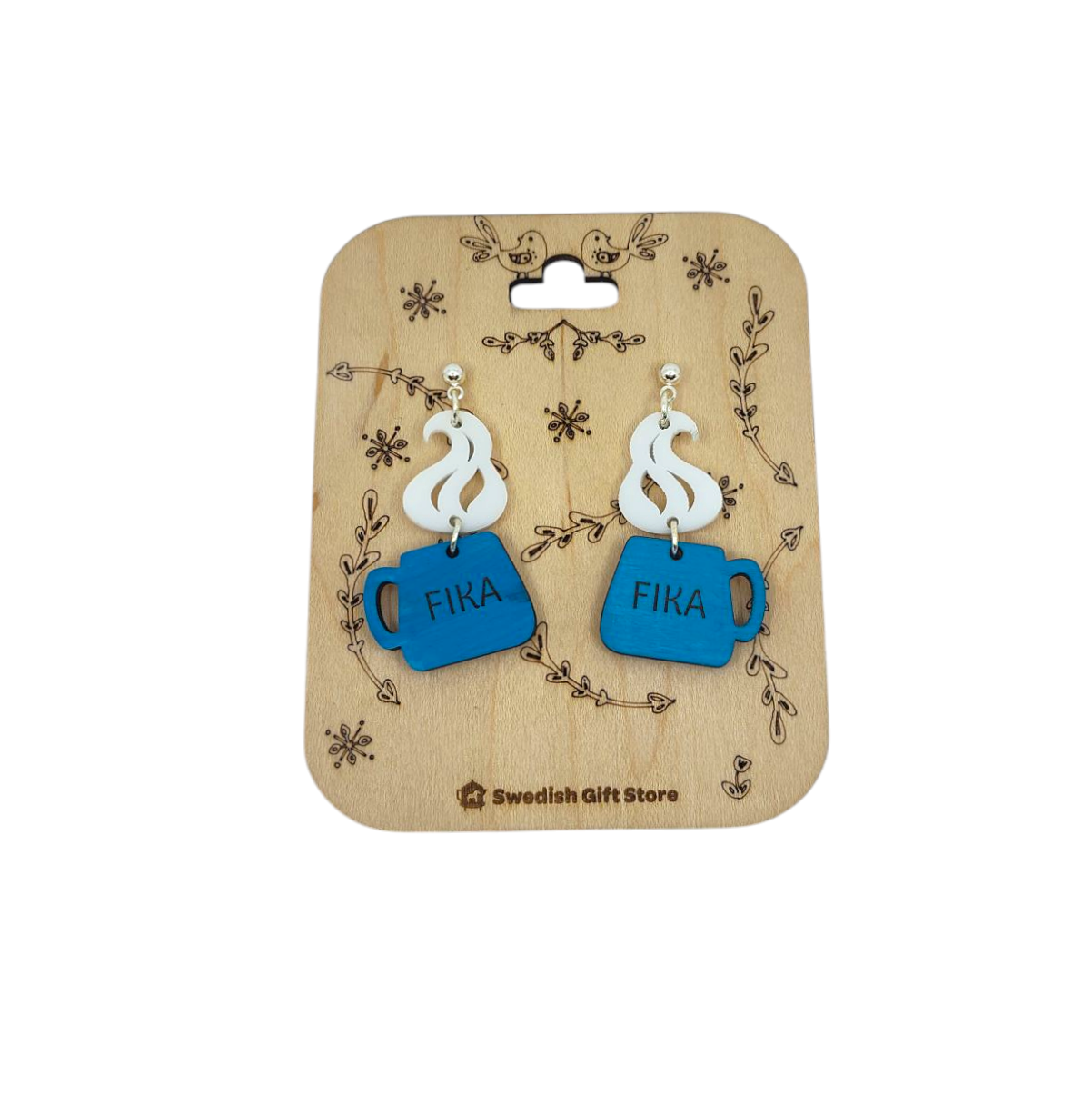 The Handmade Fika Coffee Cup Earrings showcase blue acrylic, cup-shaped designs with FIKA and steam details, beautifully displayed on a decorative wooden card.