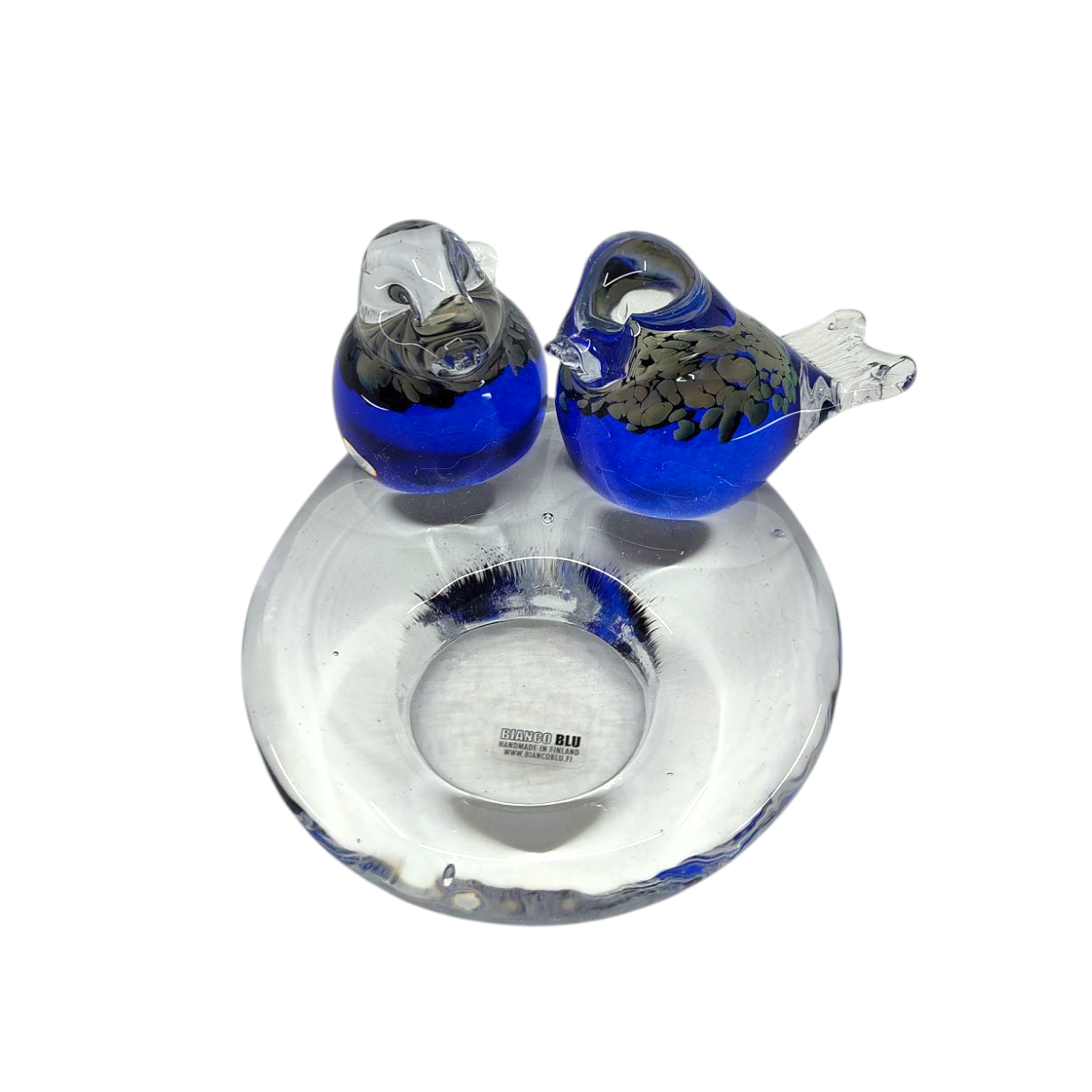 A stunning glass sculpture, the Candle Holder: Glass Candle Holder w/ 2 Blue Birds, features two elegant blue birds on a circular base, also serving as a charming tealight candle holder with a small cavity.