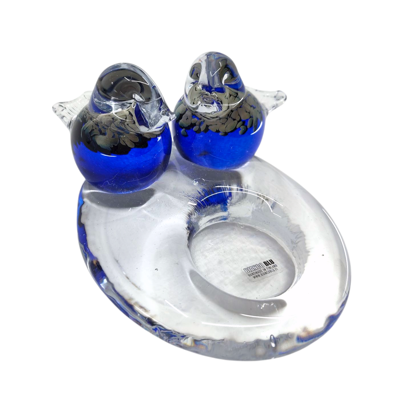 The Candle Holder: Glass Candle Holder w/ 2 Blue Birds features two elegantly perched blue and clear glass birds on a transparent ring-shaped base, creating a stunning centerpiece for tealight candles.