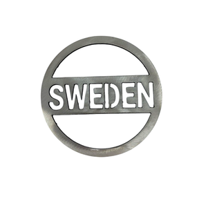 The Sweden Steel Trivet is a round metallic badge made from thick steel, showcasing SWEDEN cut out in capital letters across the center.