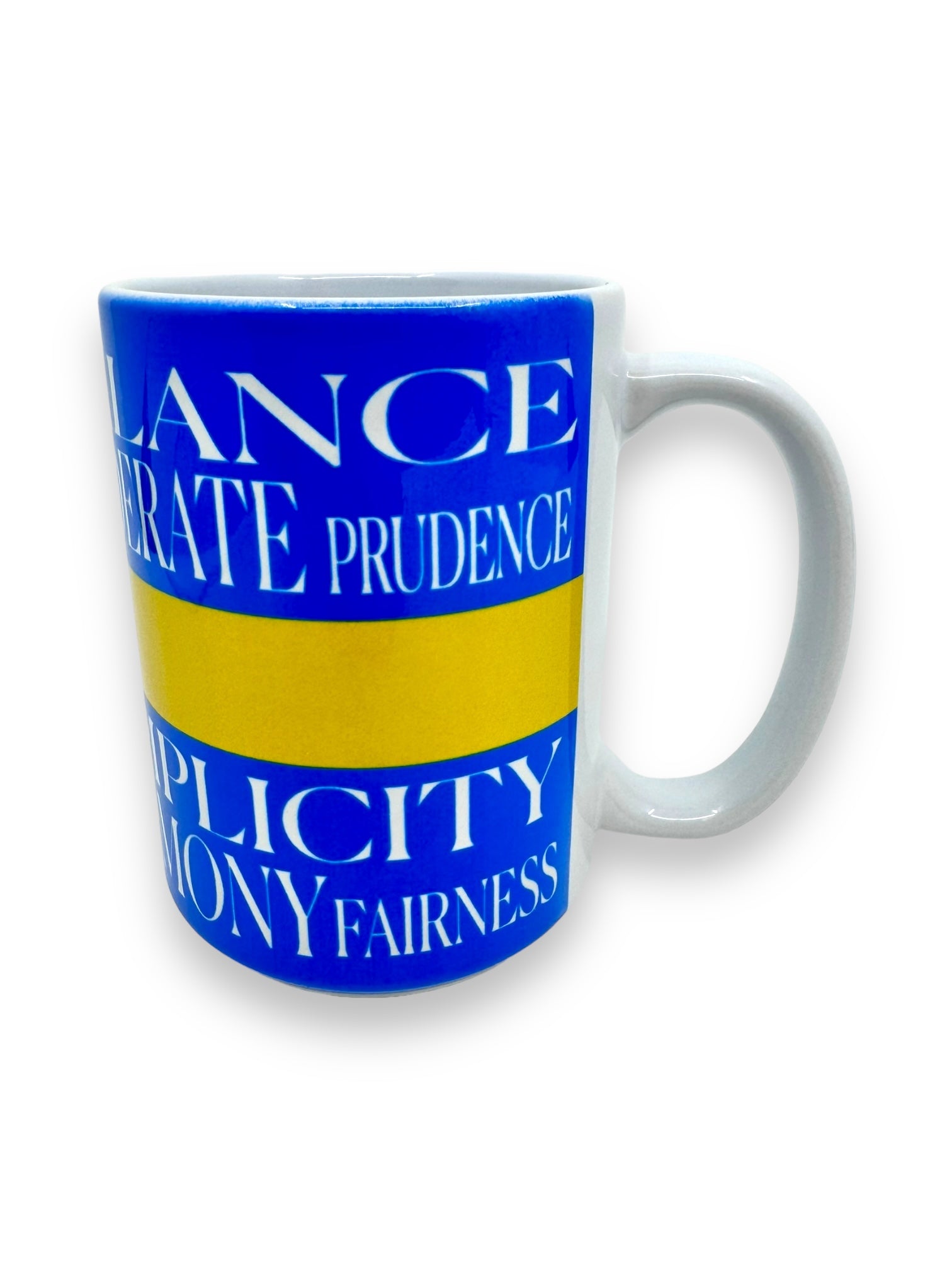 The "Lagom" Mug (15oz) in blue ceramic showcases white text with the words BALANCE, PRUDENCE, SIMPLICITY, and FAIRNESS, separated by a yellow stripe. This design embodies the Swedish concept of "Lagom," symbolizing perfect balance and purpose.