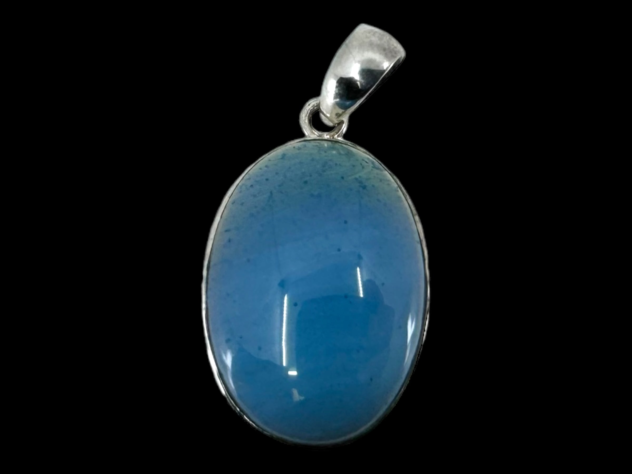 The Plain Oval - SwedishBlue pendant features a breathtaking Swedish Blue gemstone, elegantly set in sterling silver against a black background.