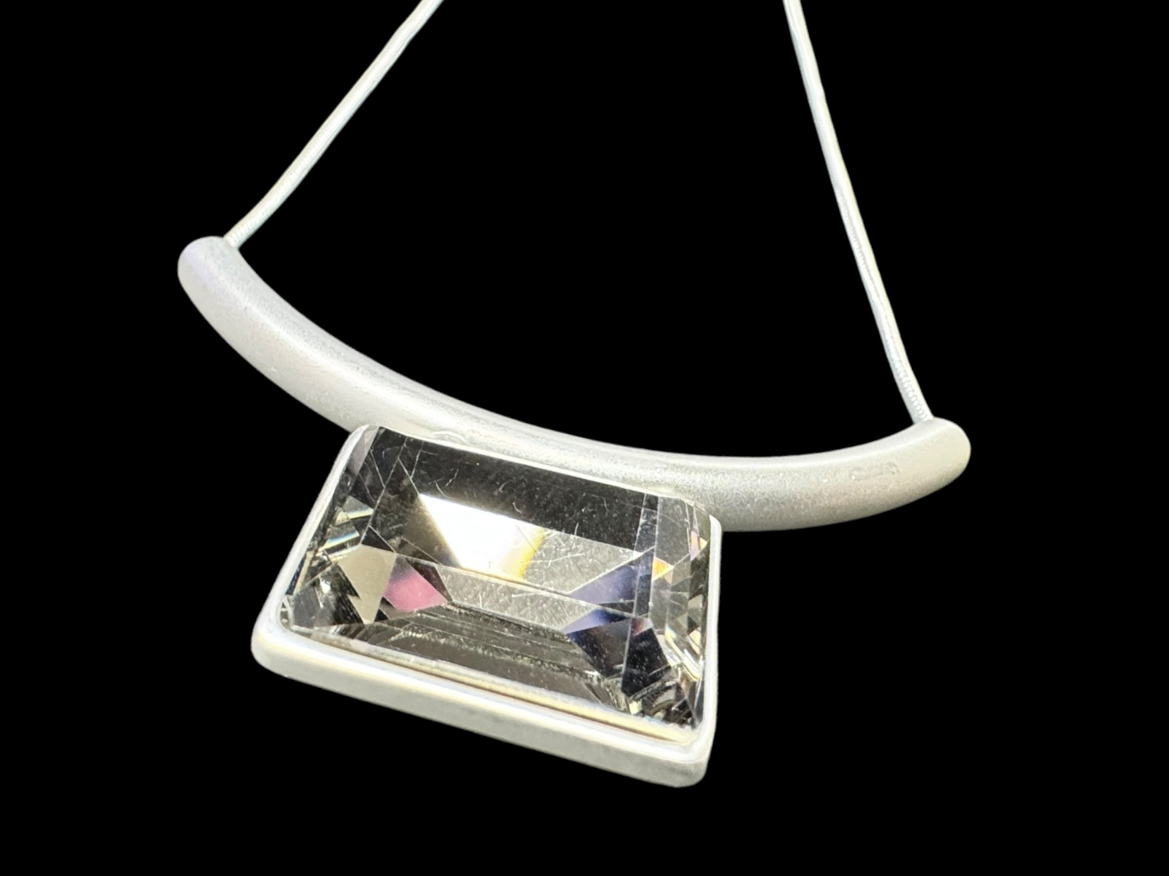 The Audrey Black Diamond Silver Plated Necklace features a minimalist Nordic design, showcasing a large rectangular clear gemstone set against a sleek black background.