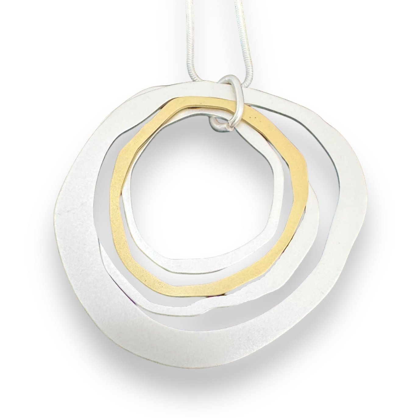 The Alaya Two Tone Elysian necklace features a versatile minimalist Nordic design with three interlocking irregular metal rings in silver and gold tones, elegantly hanging from a thin chain.