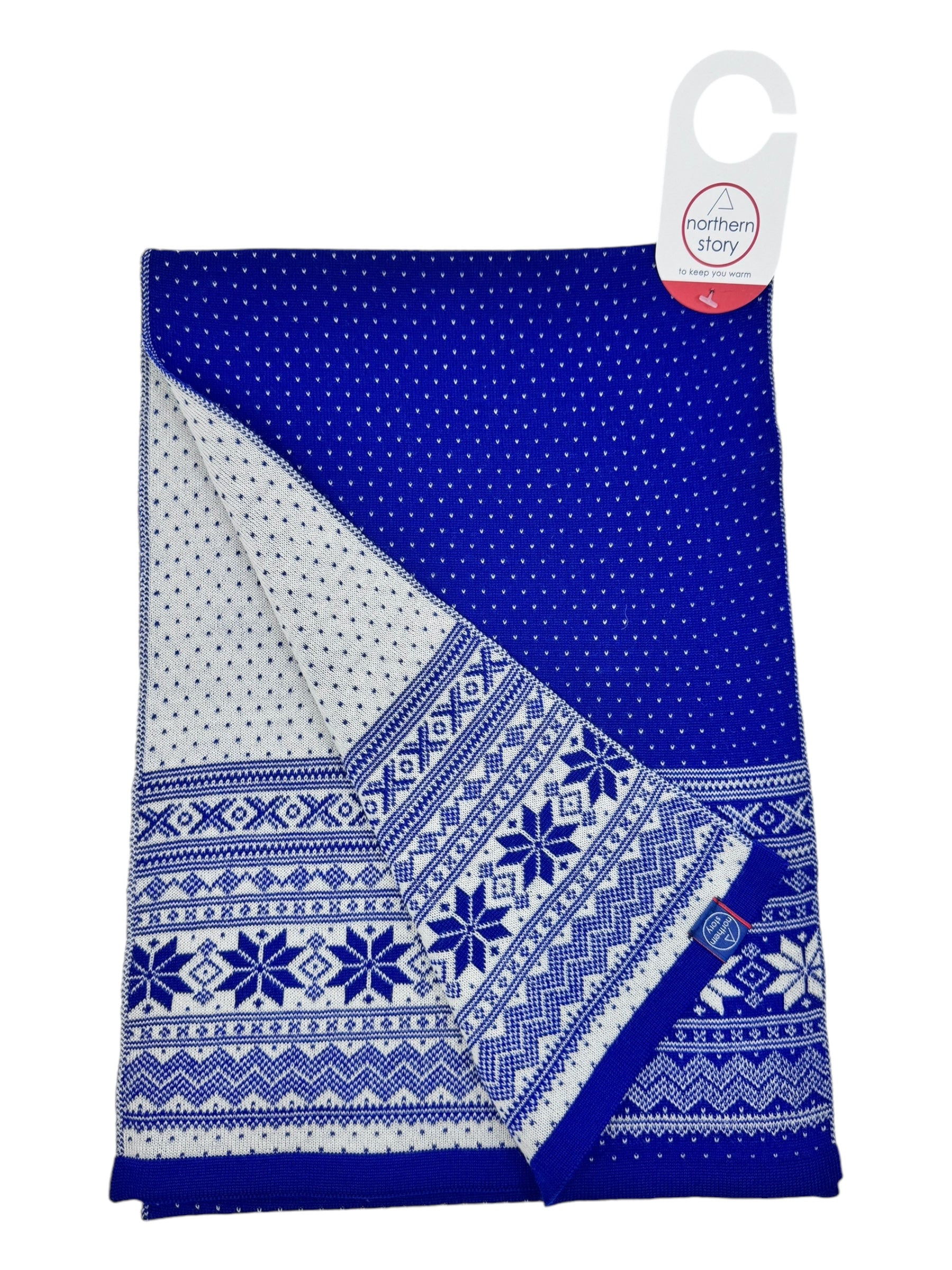 Cardigan Setesdal Royal Blue scarf, featuring blue and white geometric and star designs, crafted from soft merino wool, partially folded with a Northern Story label.