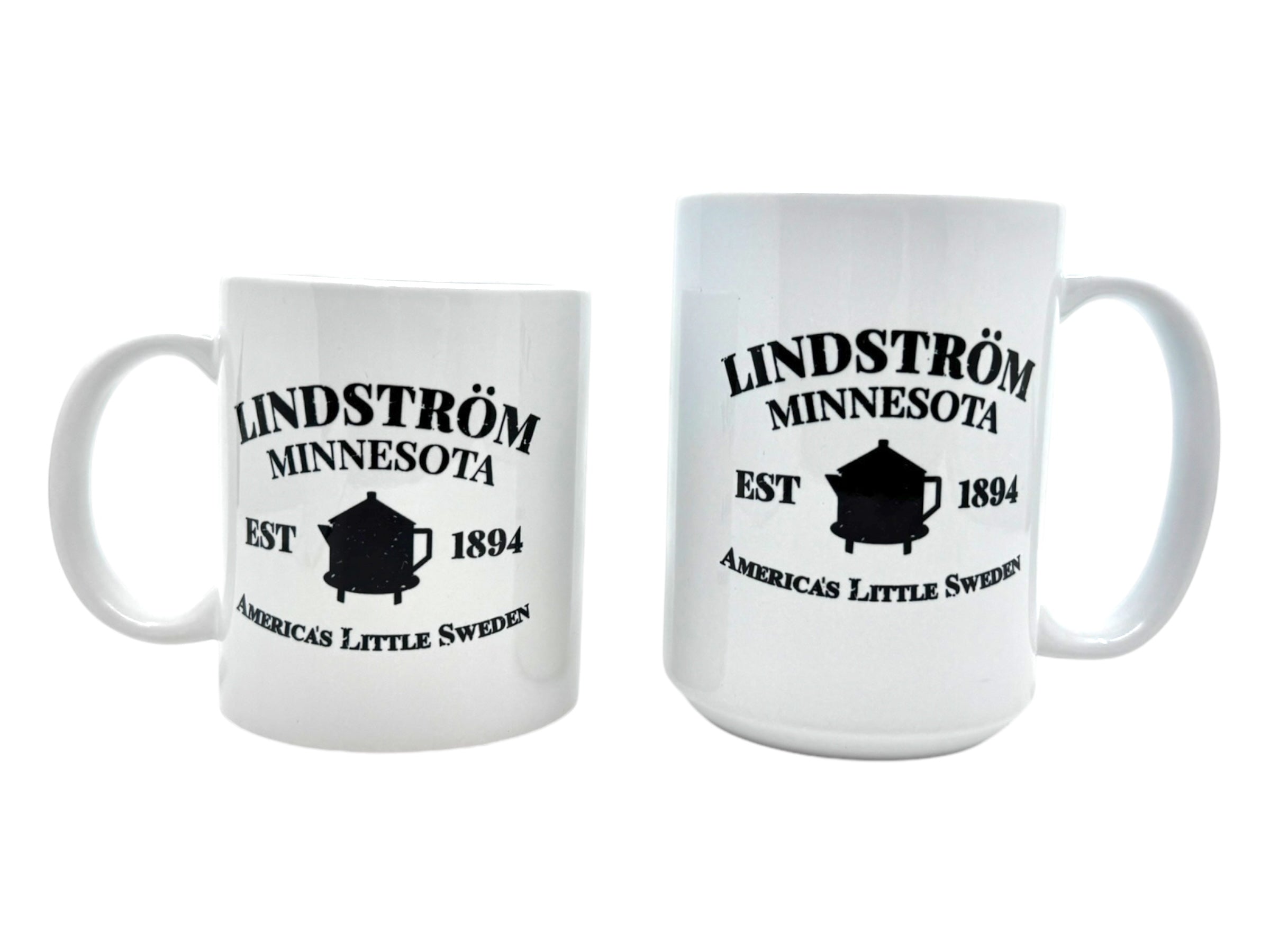 Pair of white ceramic mugs imprinted with "Lindström Minnesota, EST 1894, America's Little Sweden" and a black coffee pot silhouette. An ideal souvenir from the Swedish Gift Store in charming Lindstrom, Minnesota.