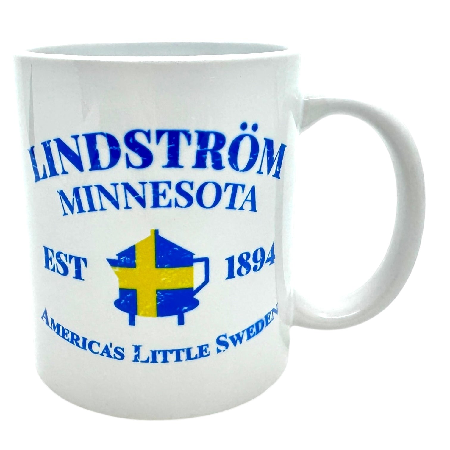 11oz ceramic mug featuring the text "LINDSTRÖM MINNESOTA" and "EST 1894" in blue, adorned with a Swedish flag motif and additional text that reads "America's Little Sweden.