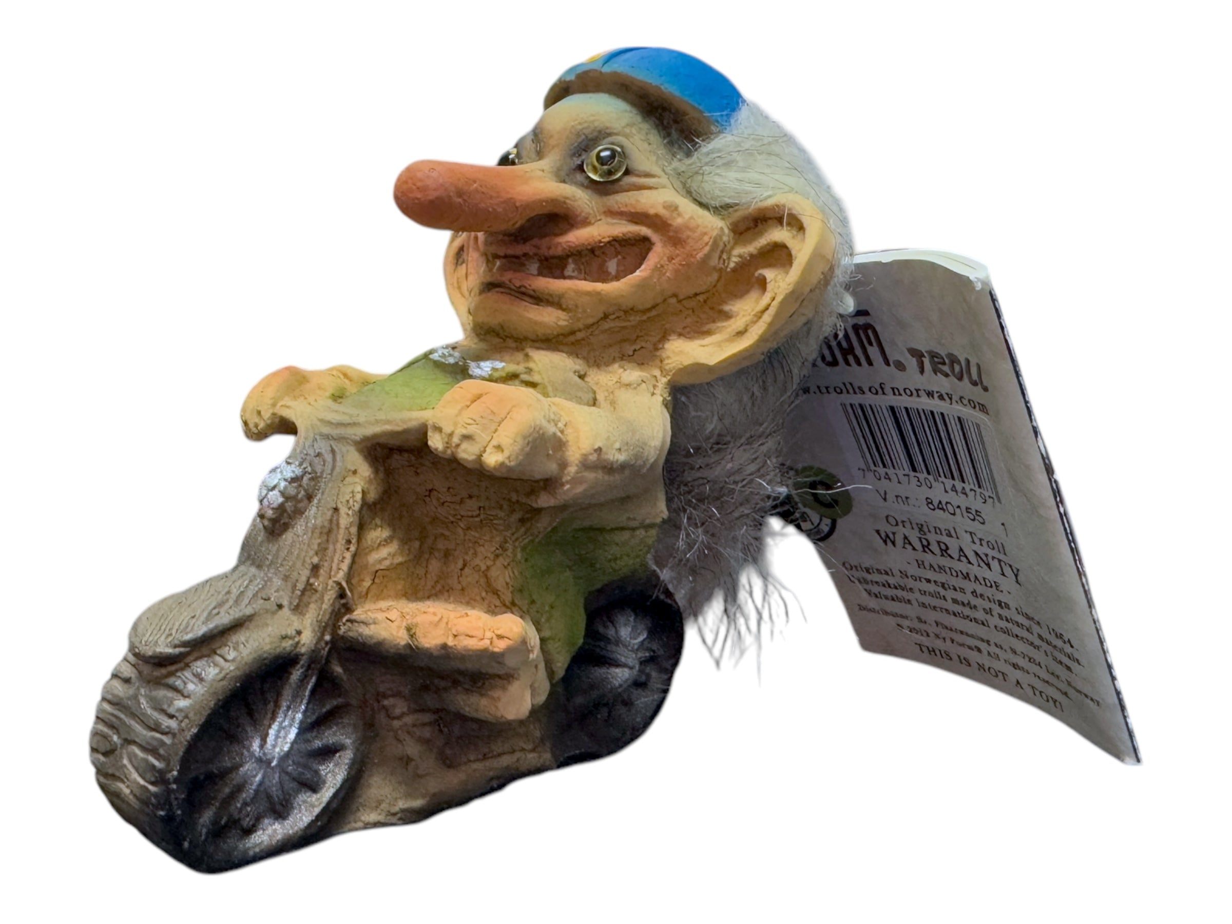 This collector's item, the Troll: NyForm - Troll on Motorcycle, features a troll riding a bike with distinct characteristics such as a blue cap, long white hair, and a prominent nose. Crafted in Norwegian design, it comes with an attached tag for added authenticity.