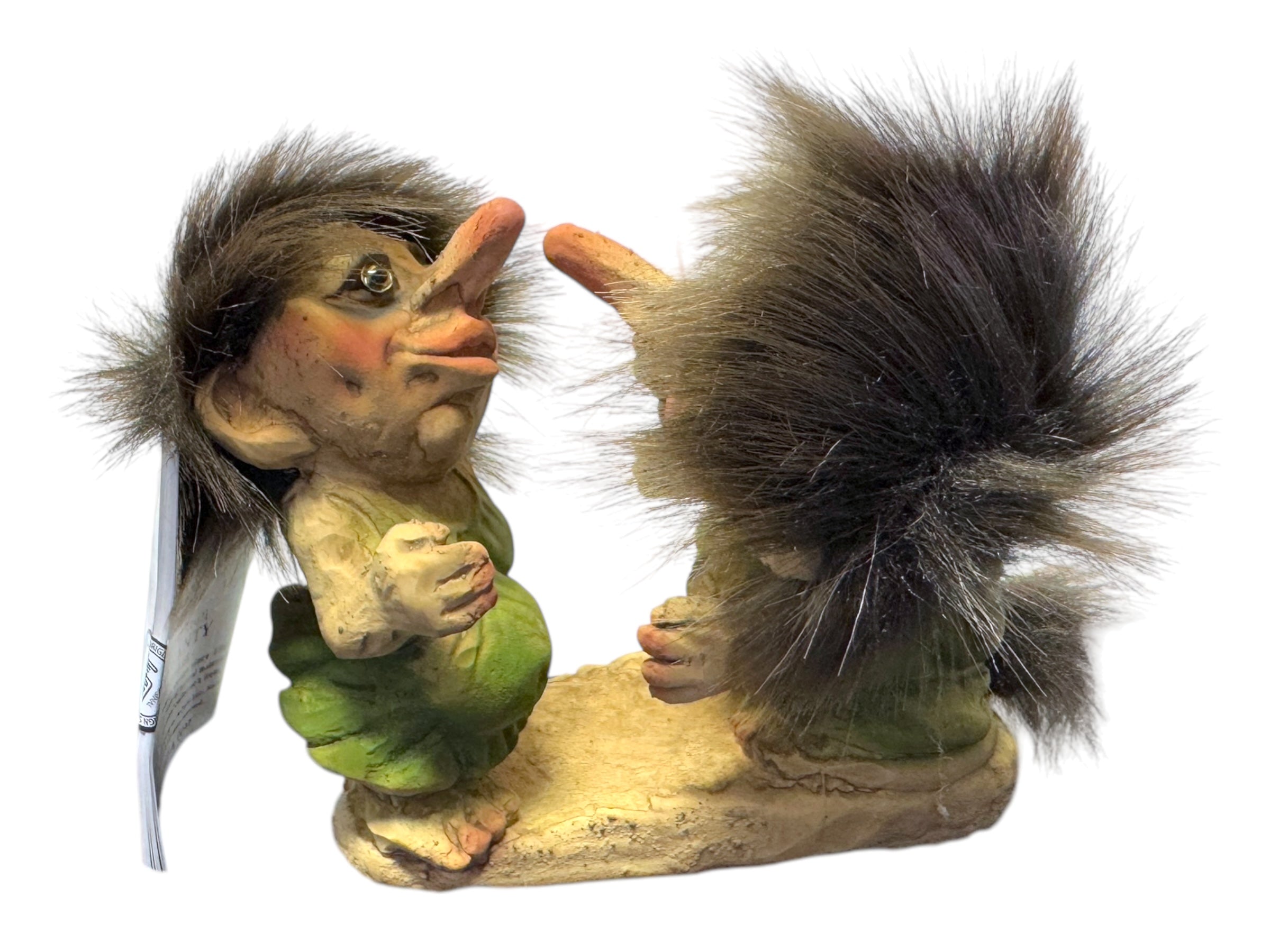 The NyForm Kissing Trolls figurine set features two small trolls with large noses and wild hair, dressed in green pants, standing on a flat base that highlights classic Norwegian design.