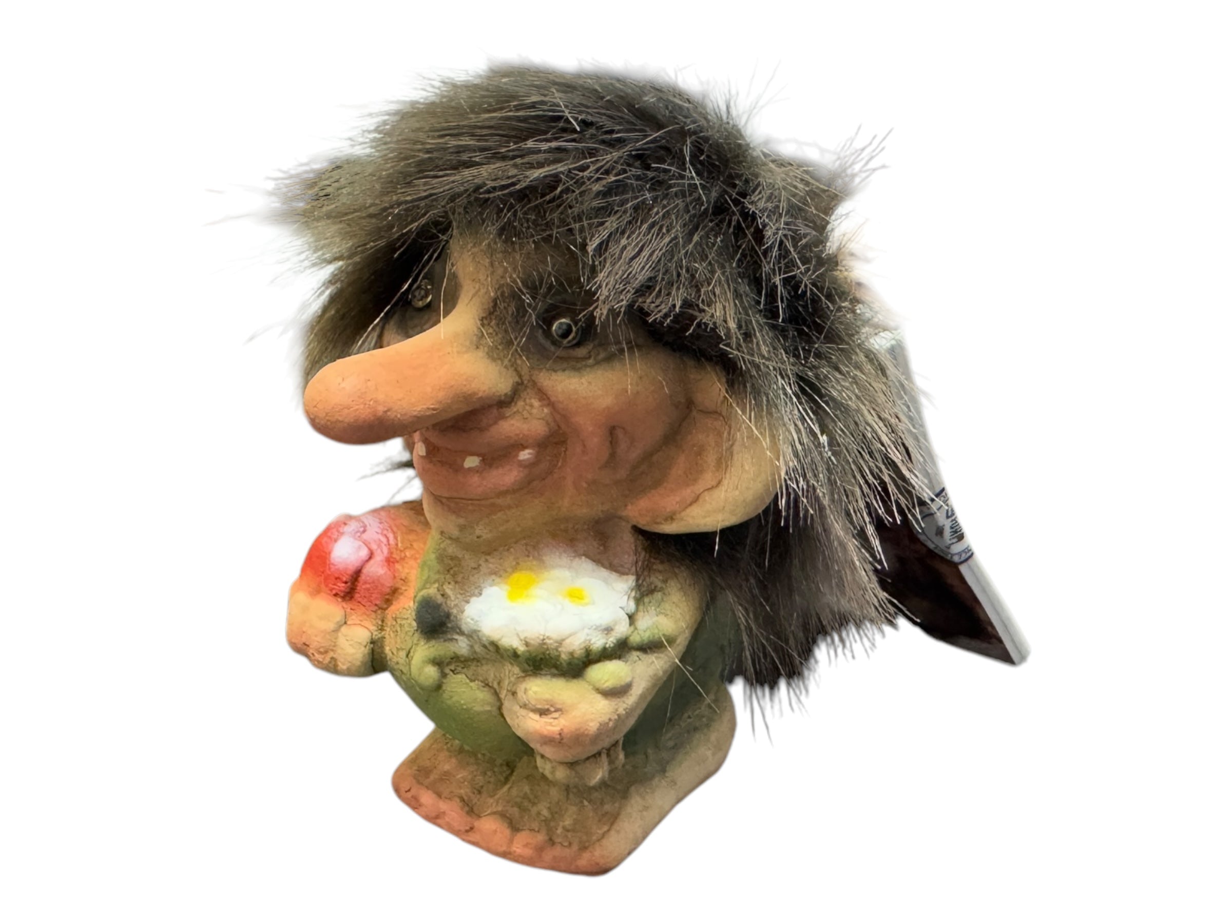 This NyForm Troll figurine, known as "Trollboy w/ Candy & Flowers," is a collectible troll with a large nose, holding a miniature flower. Its shaggy mane and cheerful expression highlight its charming, handmade Norwegian design against a plain background.