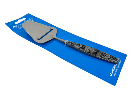 The Cheese Slicer: Sweden Metal Cheese Slicer features an ornate handle with Nordic style and is presented on blue souvenir packaging marked Norway.