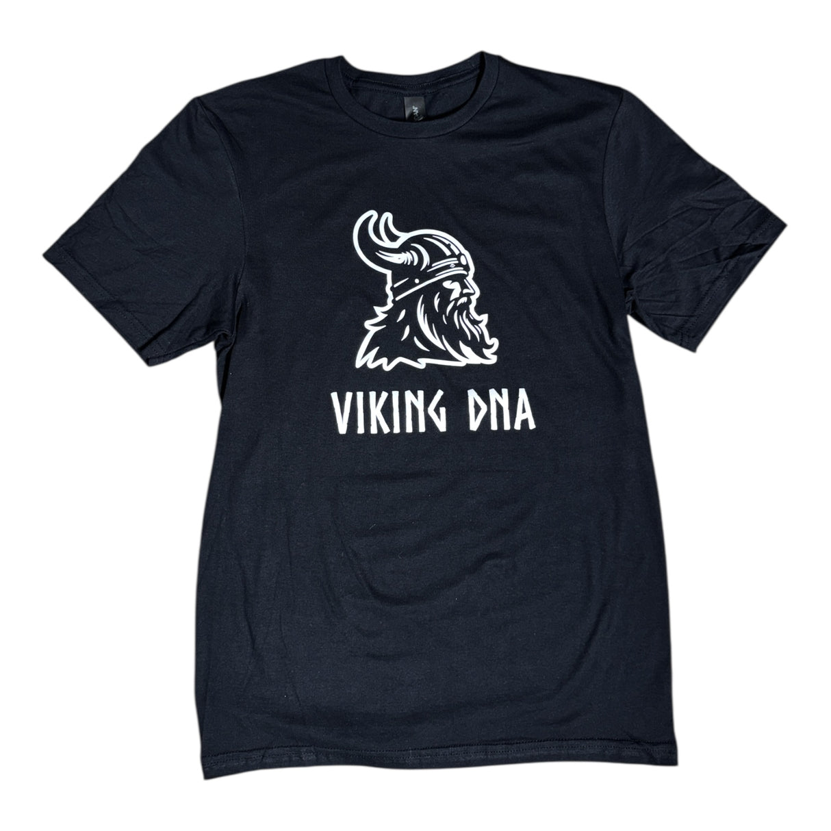 The Nordic Viking DNA Heritage Tee features a bold Viking helmet and beard graphic above VIKING DNA text—ideal for Norse mythology fans and heritage pride. Available in Black, Graphite, or Navy.