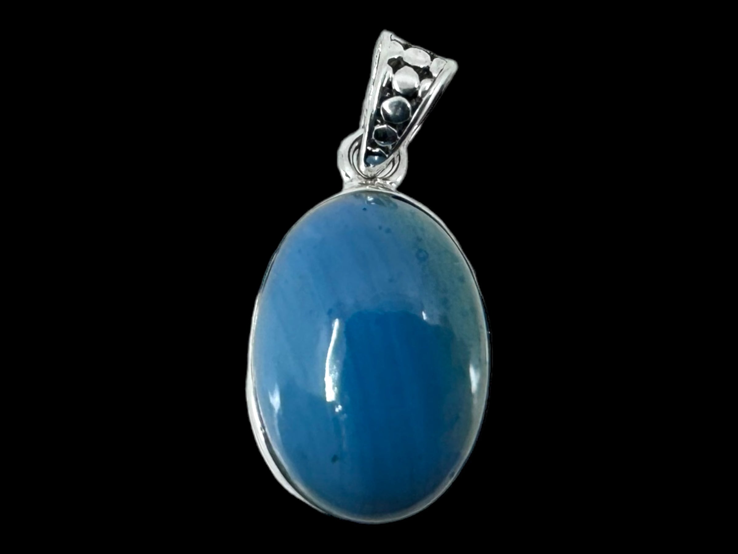 Product Data:
  Title: Pendant: Plain Oval - SwedishBlue
  Description: A beautifully crafted oval pendant featuring a stunning Swedish Blue gemstone set in a sterling silver frame, complete with an elegant decorative bail.