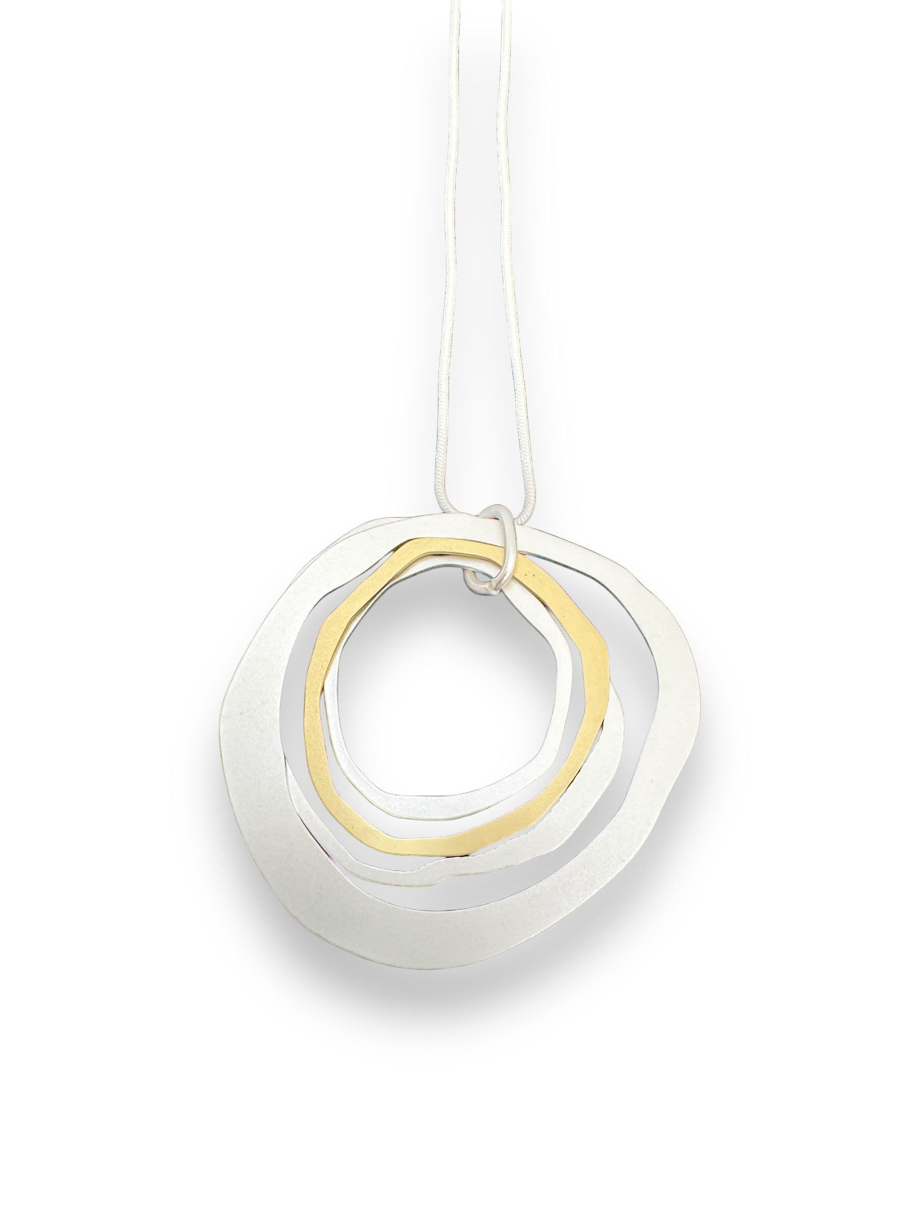 Introducing the Necklace: Alaya Two Tone Elysian, a versatile piece reflecting minimalist Nordic jewelry design. This pendant features three irregular, overlapping circular rings—two in silver and one in gold—gracefully suspended on a white cord.