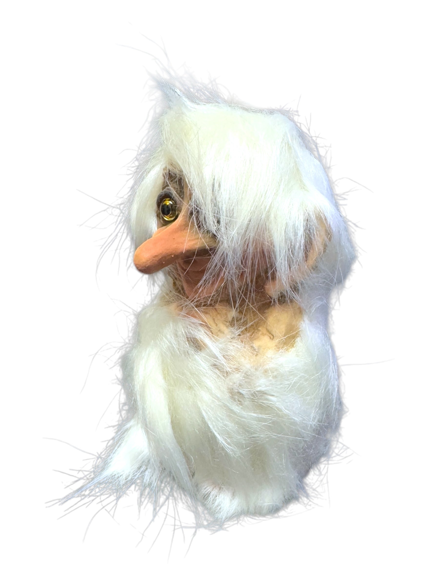 A stuffed Troll: NyForm with fluffy white fur, an orange beak, and a yellow eye, set against a white background. This charming piece features a handmade Norwegian design, making it a perfect collector's item for enthusiasts.