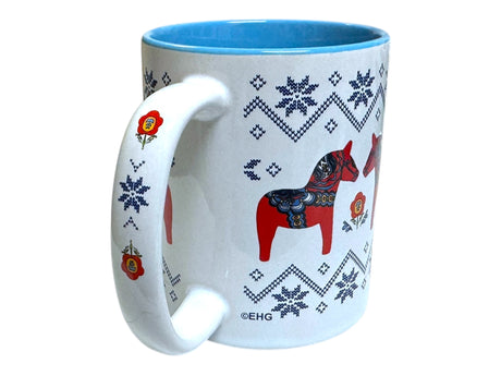 The Coffee Mug: Swedish Dala Horses with Ice Star Design - Blue Interior features red Dala horses and blue snowflake patterns on white ceramic, plus floral accents on the handle for a Scandinavian-inspired touch.