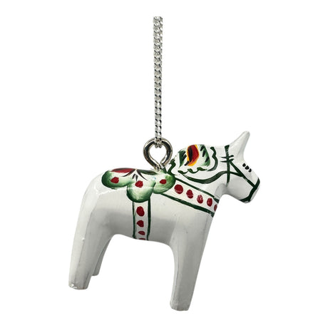 The White Dala Horse Pendant Necklace features a 2cm handcrafted pendant with Swedish folk art-inspired green, red, and yellow designs on a sterling silver 19" chain.