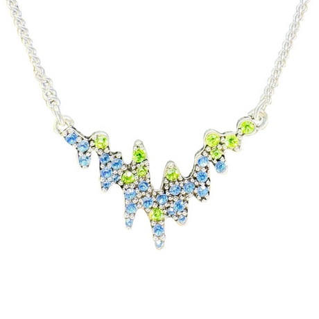 Inspired by Norwegian jewelry, the Necklace: Northern Lights A&C Oslo Norway features a silver chain and a jagged pendant adorned with blue and green crystals in a striking, wave-like pattern.