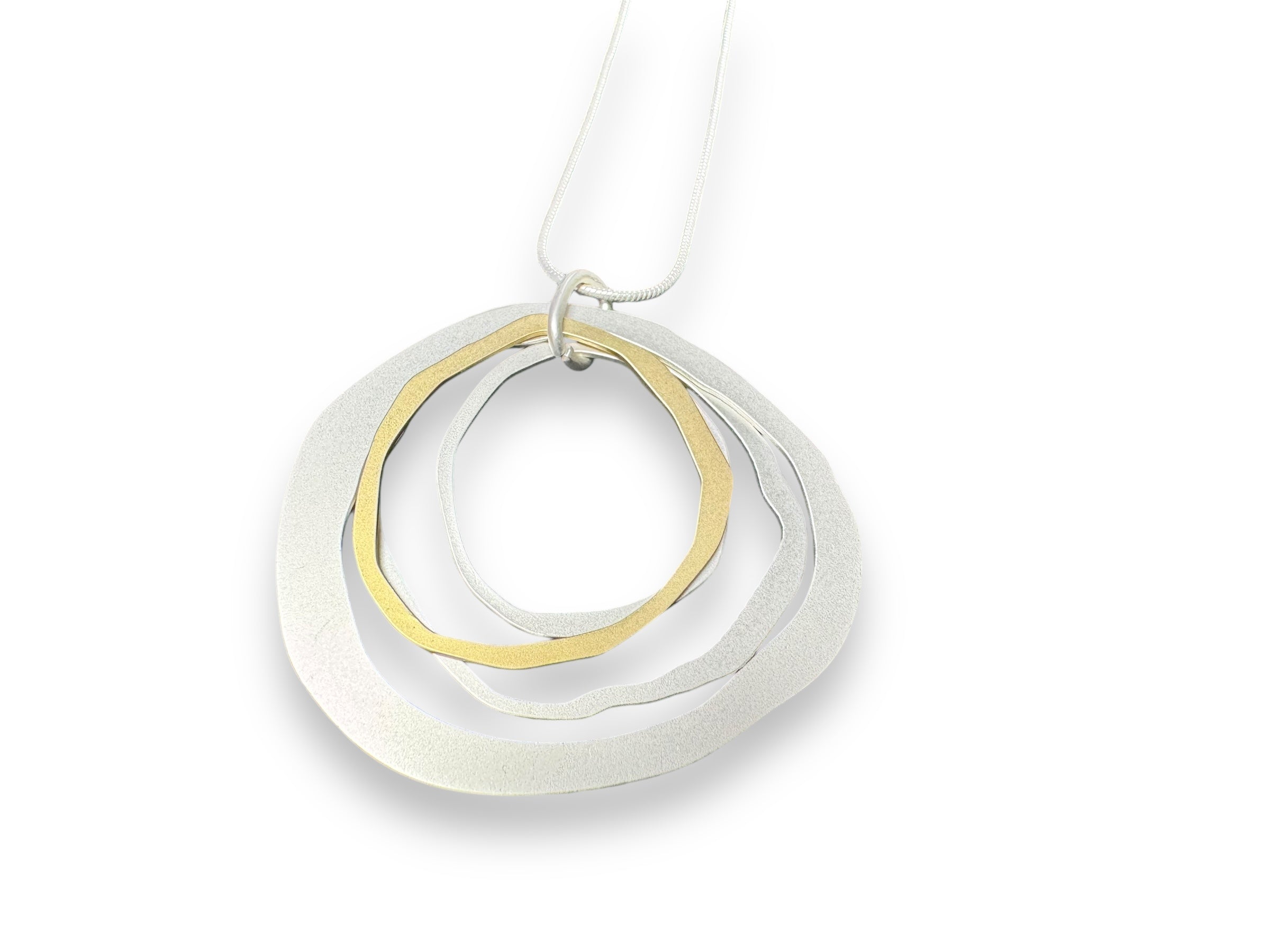 The Alaya Two Tone Elysian necklace is a versatile piece featuring circular, interlocking metal pendants in silver and gold, epitomizing minimalist Nordic jewelry.