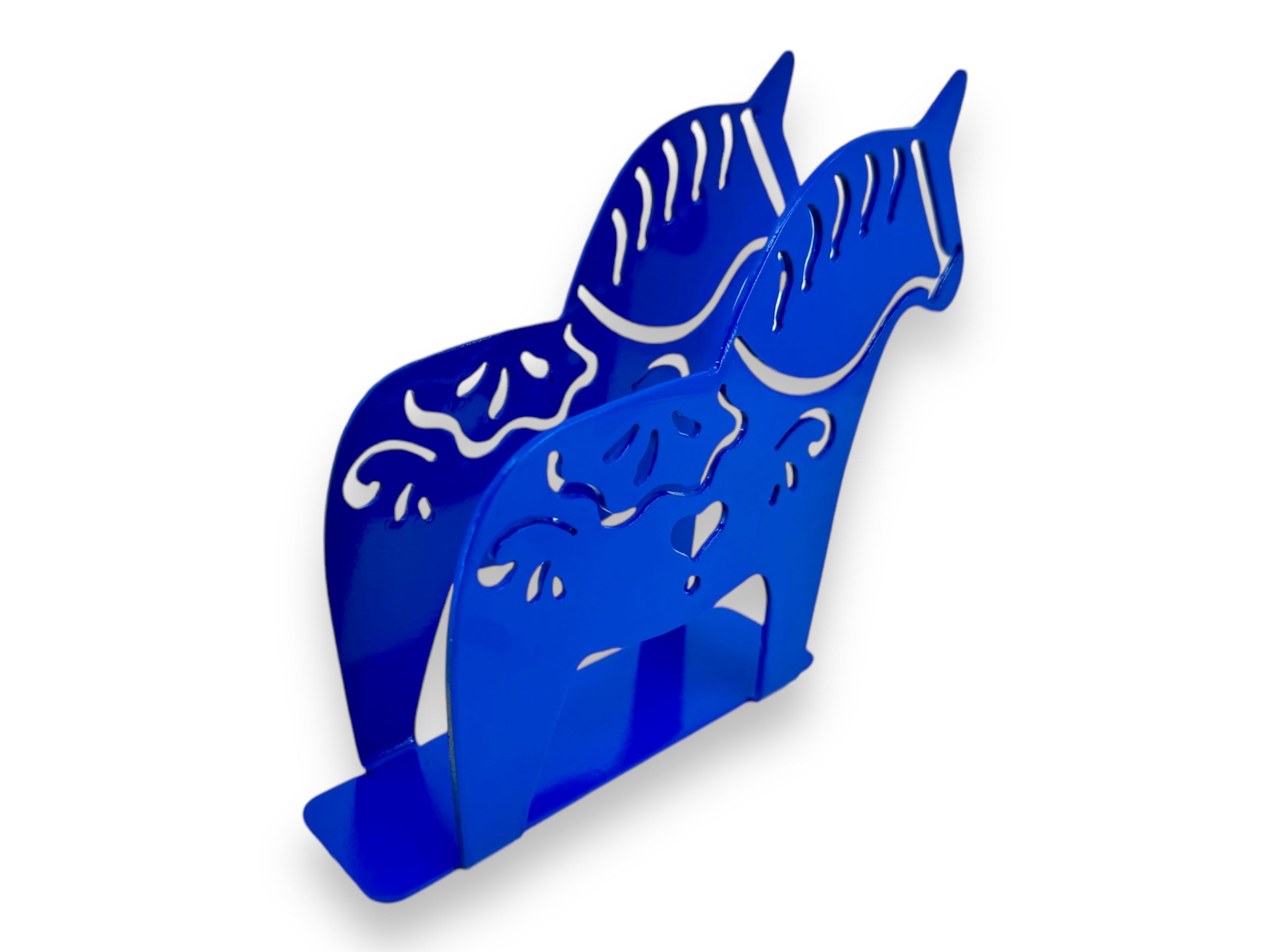 A blue metal napkin holder shaped like a stylized horse, featuring intricate laser cut details inspired by kurbits designs.