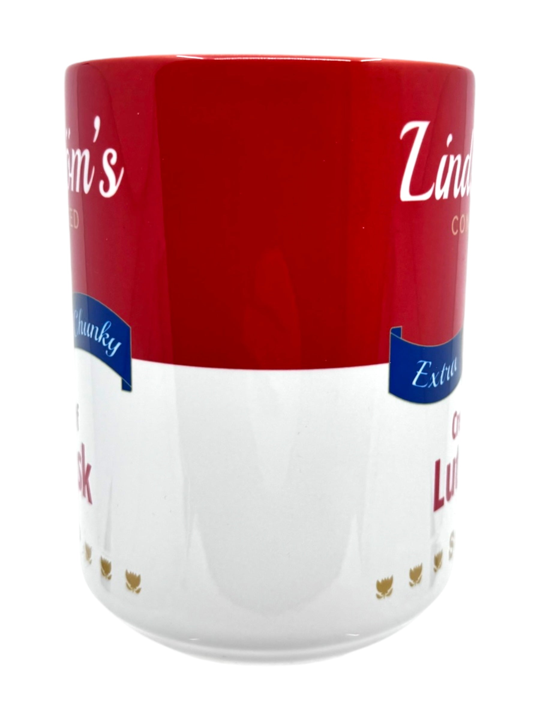 This ceramic mug, designed with a red and white color scheme, showcases the text "Lindstrom's Cream of Lutefisk Soup" along with additional phrases in blue banners. It's ideal for cozy evenings spent with the Vilhelm Moberg series or for enjoying a warm bowl of lutefisk soup.