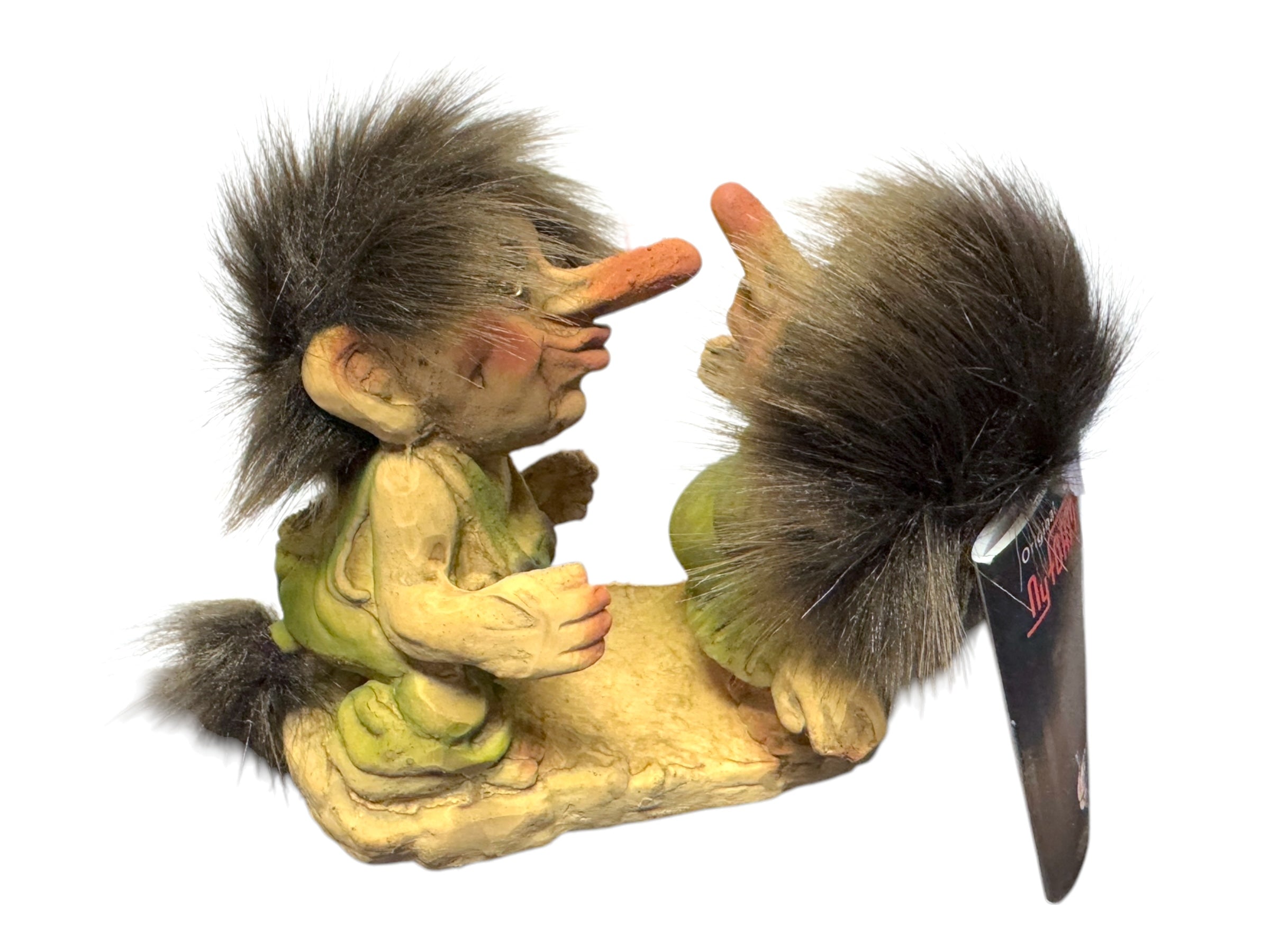 The "Troll: NyForm - Kissing Trolls" features two whimsical figurines facing each other, with exaggerated noses, fluffy hair, and green outfits, all set on a textured base—a testament to Norwegian design.