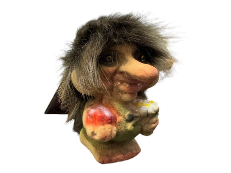 The NyForm Troll Boy with Candy & Flowers figurine, featuring a furry mane and large nose, stands out against a plain background. This delightful piece embodies Norwegian design and is a unique collectors item.