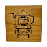 Square Alder Coaster (4x4) featuring the Lindstrom Coffee Pot Water Tower and Välkommen till Lindström—a perfect nod to Swedish FIKA and Lindström, Minnesota.