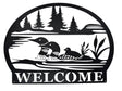 Welcome Loons Wall Decor in matte black metal (23 × 17) features three loons on a lake with trees and cattails, and WELCOME at the bottom—an ideal piece of Scandinavian-inspired art for your home.